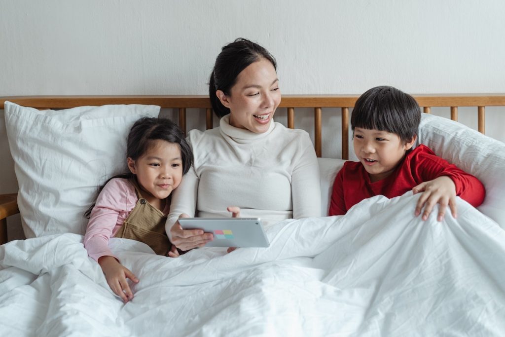 Family under blanket enjoying air conditioning.